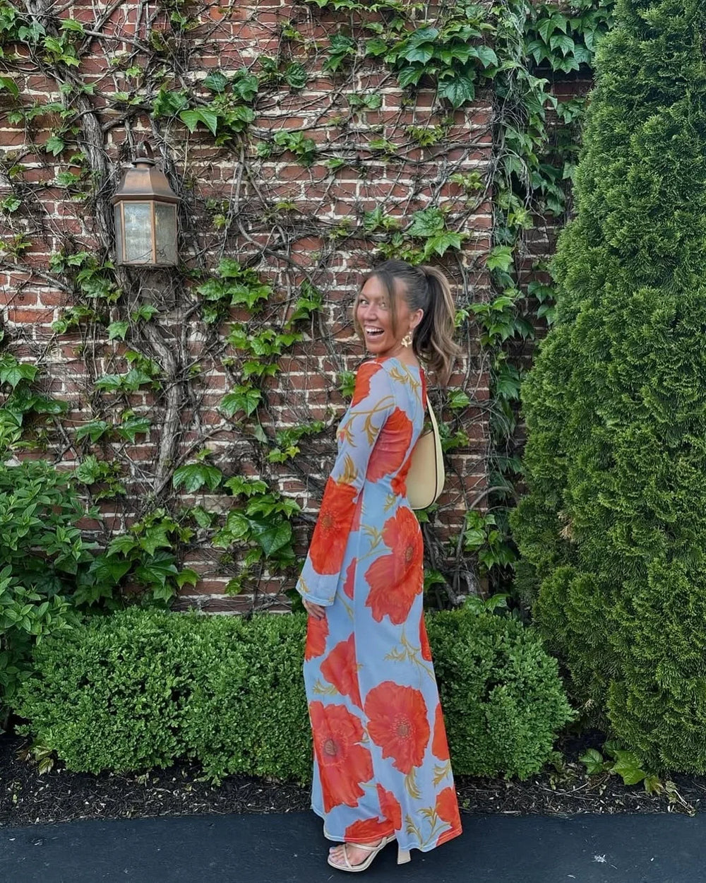 side angle showing slim column silhouette of blue floral maxi