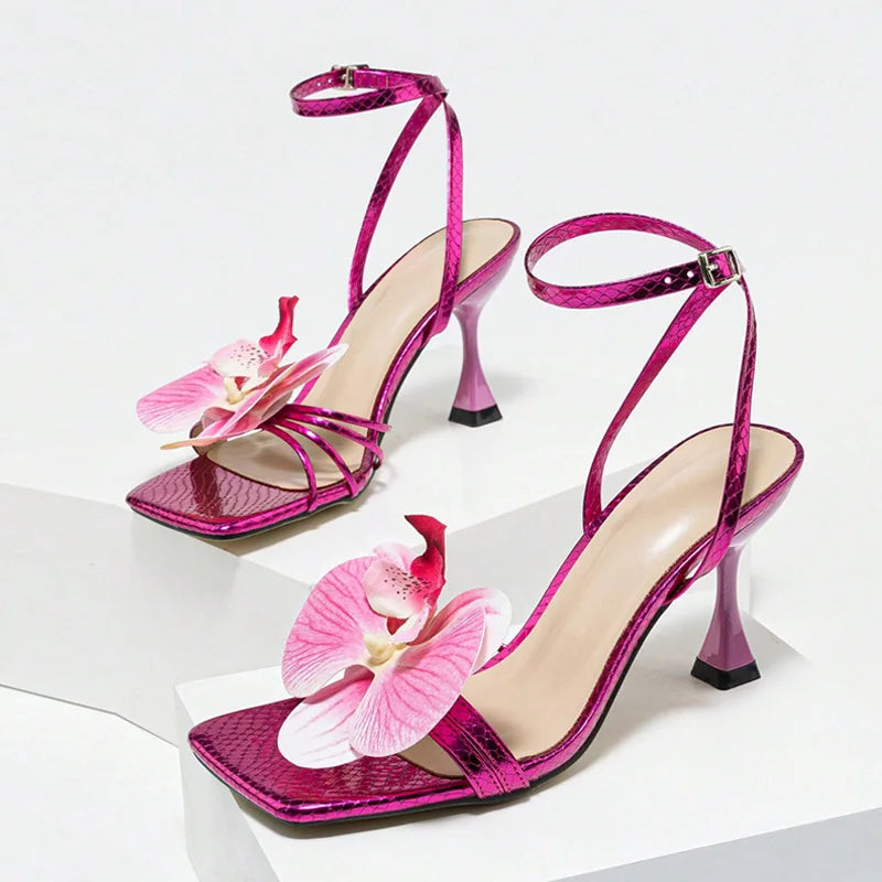 Elegant purple platform gladiator sandals paired for formal wear. Pink high-heeled sandals with floral decorations on a white background