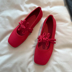 Soft sole red satin Mary Jane flats displayed side by side