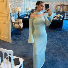 An elegant sheath party gown styled with heels and a clutch.