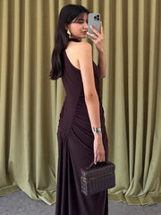An elegant sheath party gown styled with heels and a clutch.