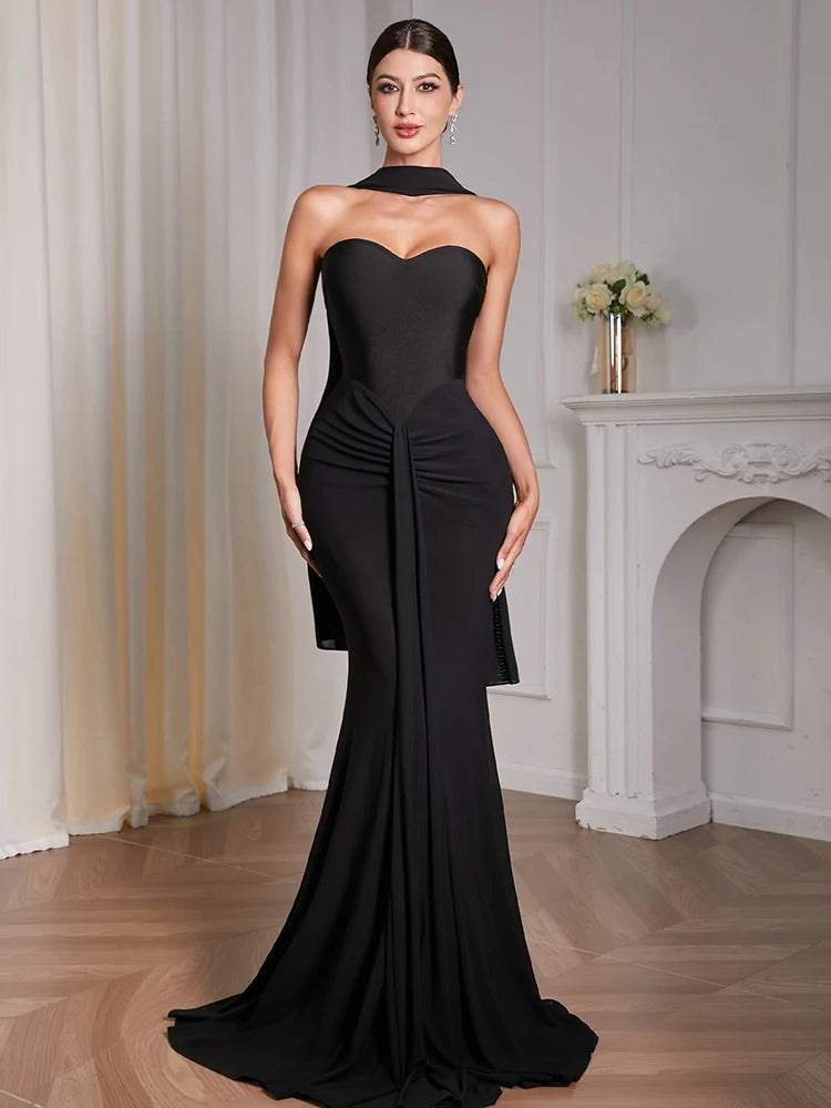 Close-up of chest-wrapped draped detailing on black sheath dress