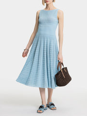 A full-length shot of a slimming draped dress, styled for a day at the office.
