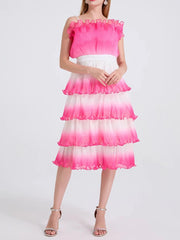 A full-length shot of a slimming ruffle dress, styled for a day at the office.