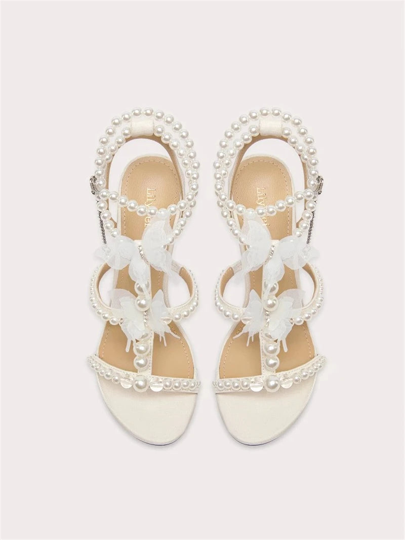 Close-up of pearl T-band detail on women’s wedding sandals