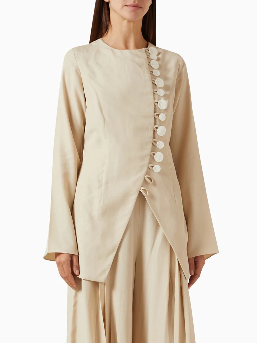 A full-length shot of an elegant women's jacket, styled for a day at the office.