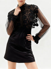 Close view highlighting intricate embroidery across the bodice and contrast with sheer sleeves