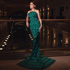 A woman wearing an elegant emerald green mermaid gown for a formal event.