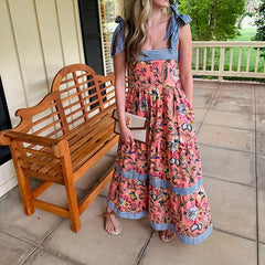 Woman in an Empire waist A-line dress, perfect for garden brunches, standing on a porch with a wooden bench.