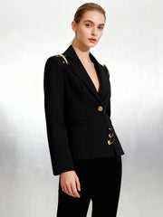 Structured black blazer styled with gold design elements
