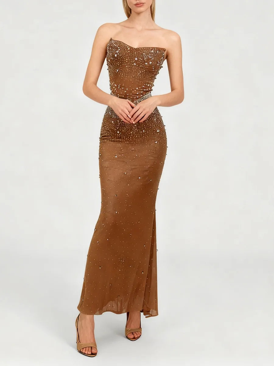 Close-up of the waist and midsection showing crystal-style detailing and slim mermaid shaping on a woven evening gown.