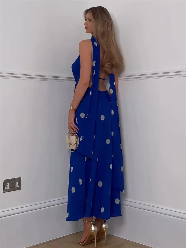 Polka dot V-neck dress styled indoors for an elegant evening look