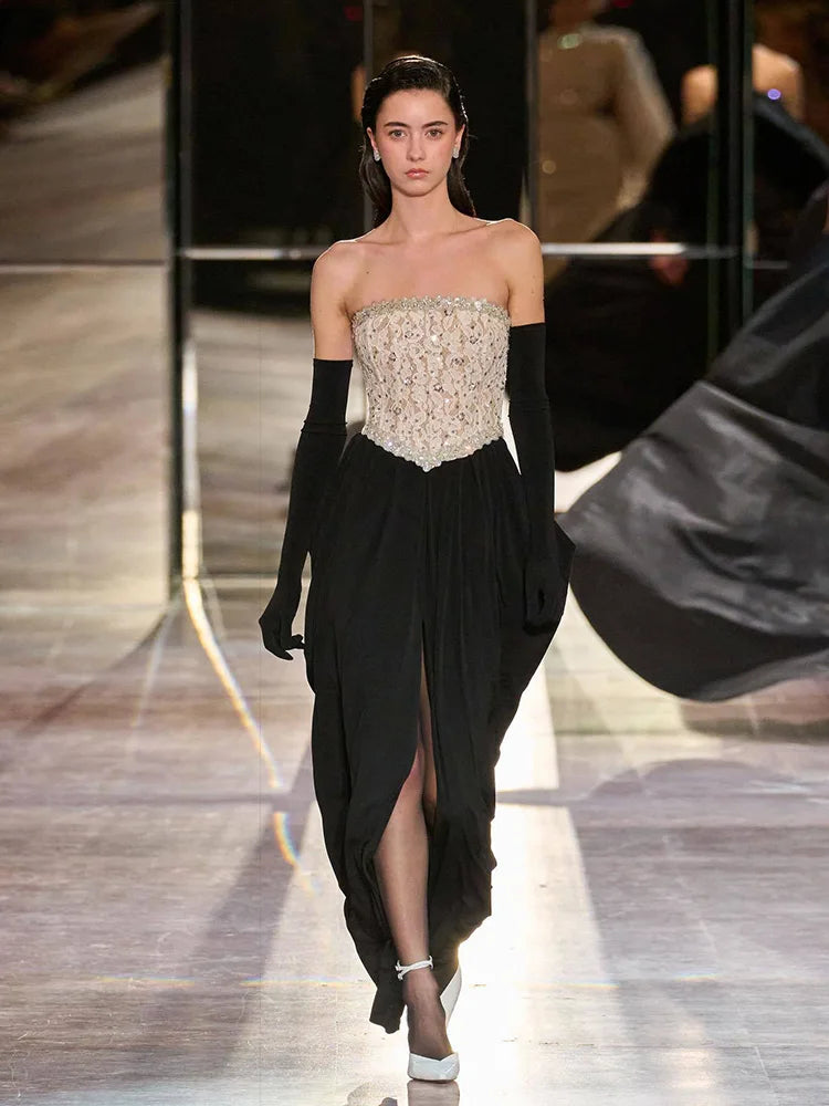 Evening look featuring long gloves and a strapless corset dress on a studio backdrop