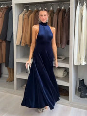 Rear view of velvet halter dress showing open-back design