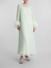 A close-up of the feather trim and diamond detail on the dress.

