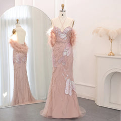 Pink evening gown with feather details on a mannequin against a white background