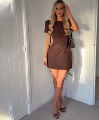 Short sleeve mini dress posed beside a wooden door