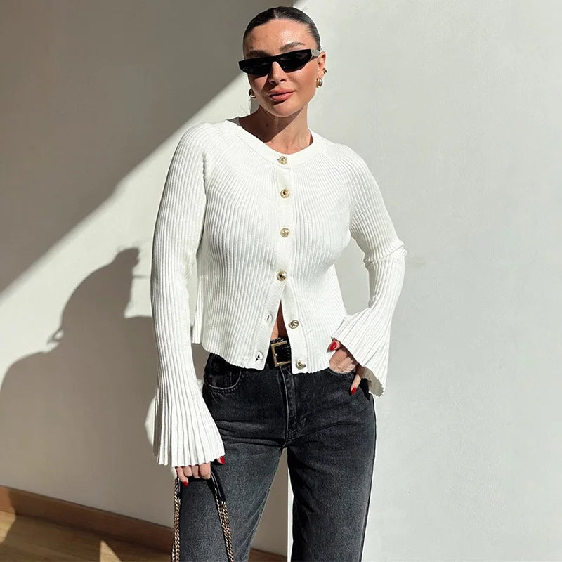 White ribbed knit cardigan styled with black jeans and sunglasses
