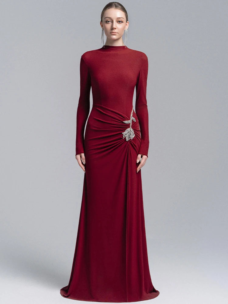 Straight-on studio shot showing the high neckline and smooth fitted bodice, with the gown falling into an elegant trailing hem