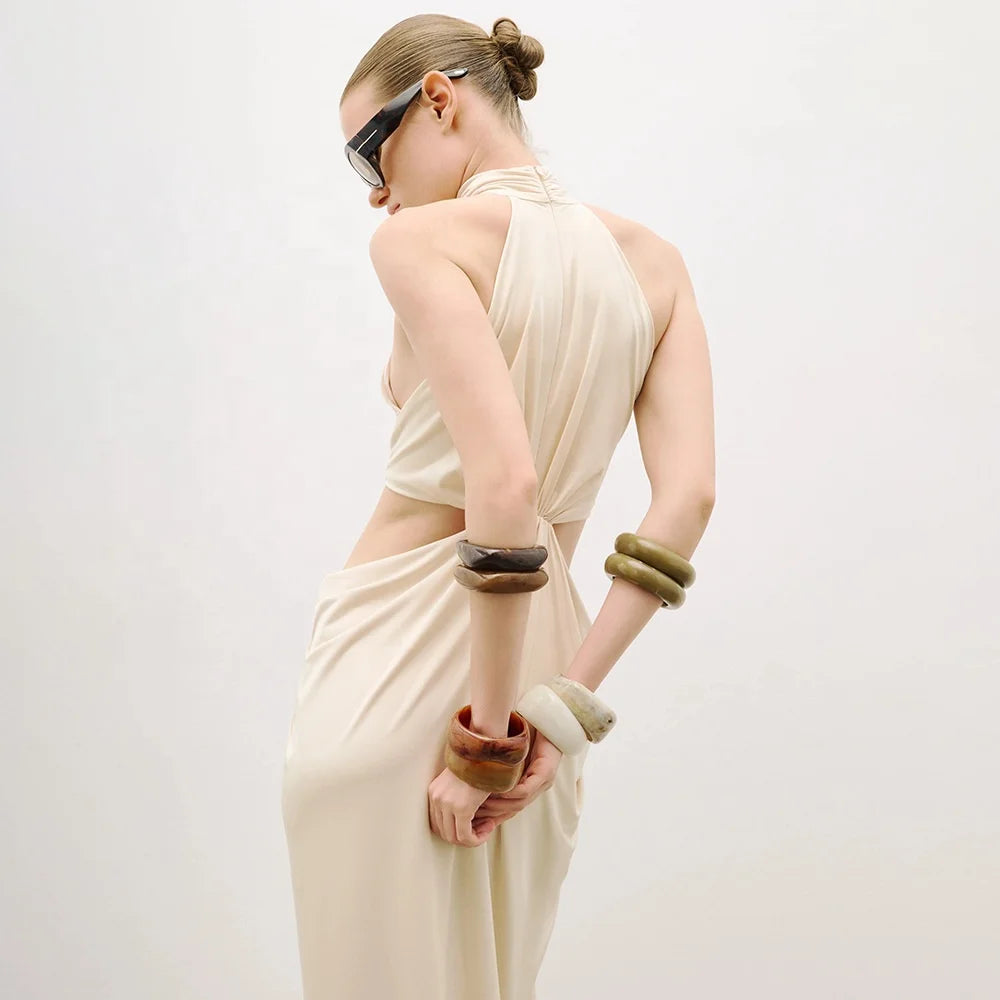 Draped maxi dress with subtle cutout accent and sleek silhouette