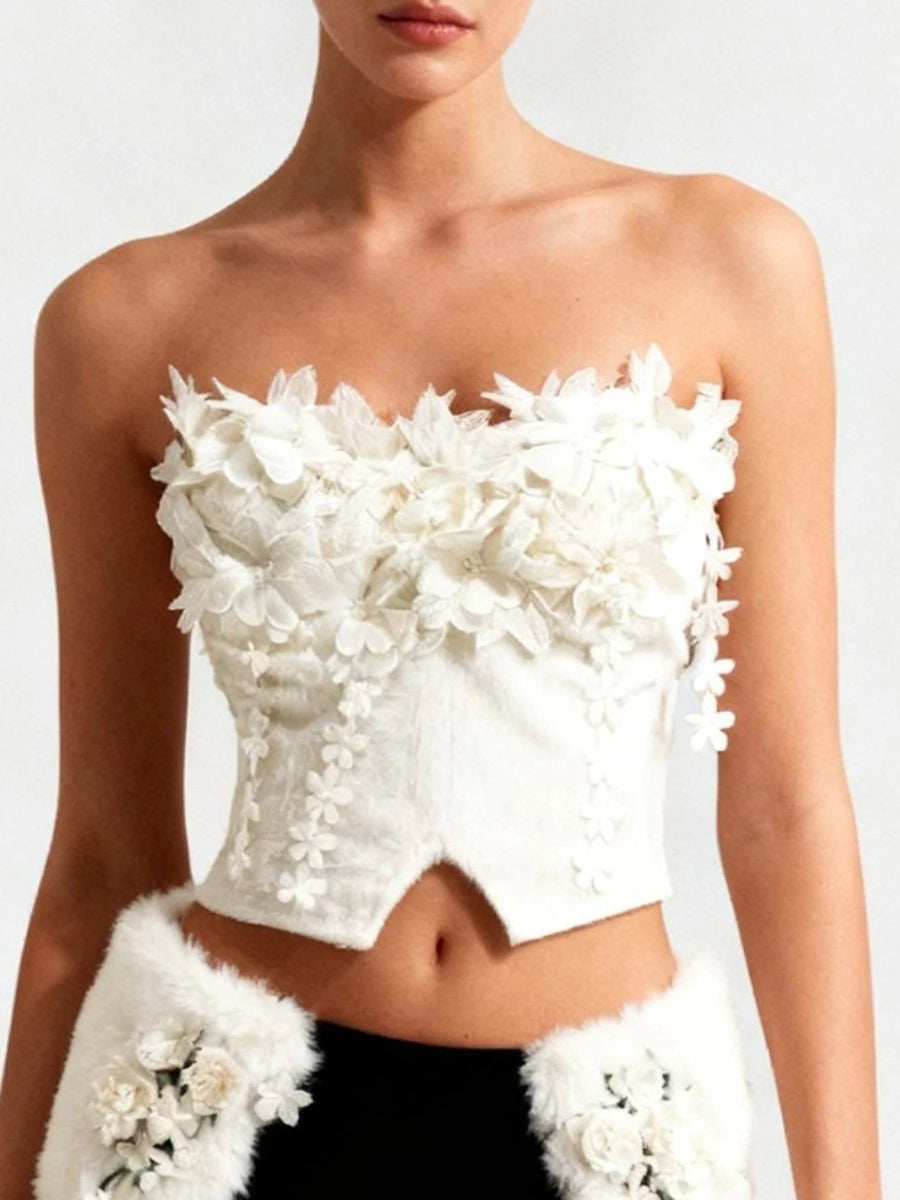Close-up of three-dimensional floral appliqué layered across the bodice, showing texture and craftsmanship