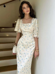 White floral satin midi dress with puff sleeves shown from front view indoors