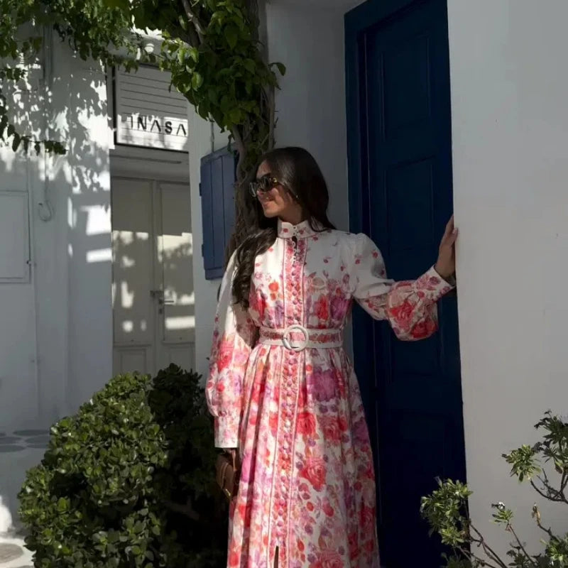 Woman in floral stand collar belted maxi dress outdoors