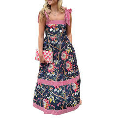Woman wearing a Floral Striped maxi dress styled for a cottagecore-inspired summer with pink accents on a white background