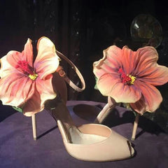 Flower applique high heel wedding shoes shown for party outfit inspiration on a dark background.