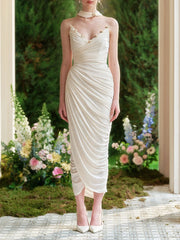 Elegant white sheath dress designed with soft vertical pleating