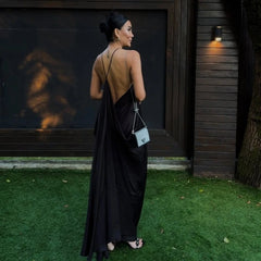side angle showing open lace-up back of black evening maxi