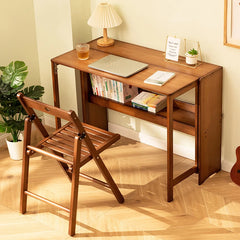 Folding desk with shelf in wood-grain finish beside a chair