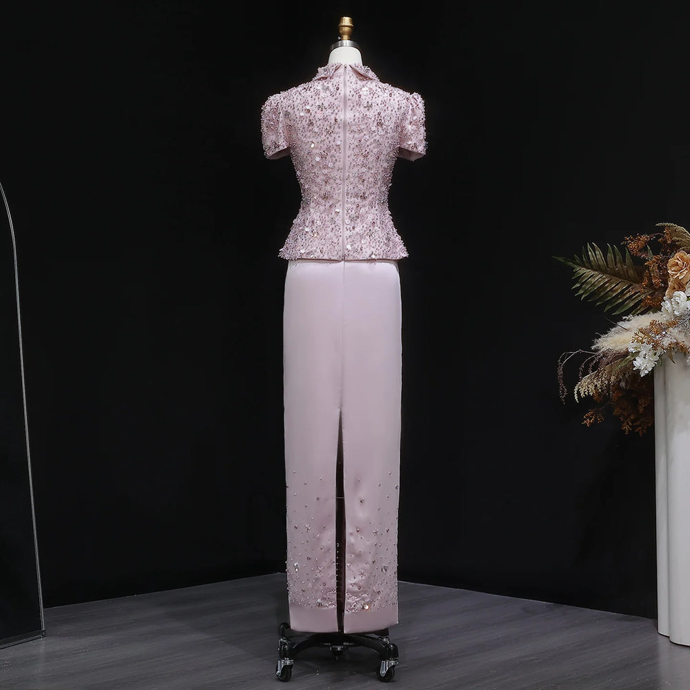 Indoor outfit shot showing the two-piece set’s refined silhouette, with the embellished top adding sparkle and the skirt keeping the look sleek.