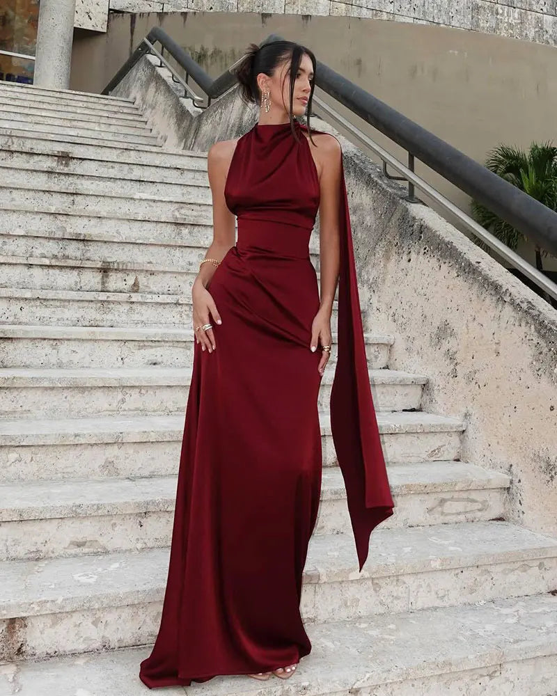 Formal burgundy halter gown styled on outdoor stone steps