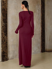 A woman wearing a Formal metal snap waist evening dress with an empire silhouette for women against a textured wall.