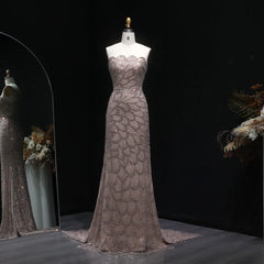 A full-length view of the formal party gown, showing the mermaid-style skirt and tulle fabric.

