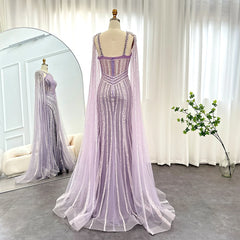 A formal trumpet dress with elegant full-length cape sleeves flowing behind the model.
