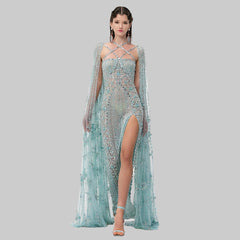 A woman modeling a fuchsia mermaid gown with a beaded and sequined bodice.