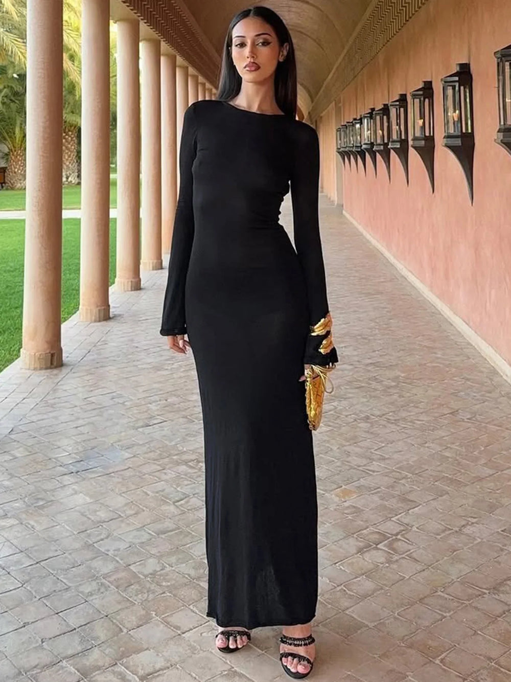 Full sleeve black and gold detail maxi dress shown for night out style