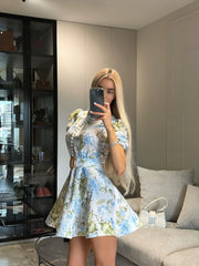 floral belted mini dress styled with sunglasses outdoors