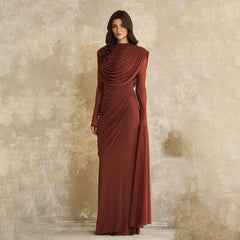 Close-up of the gathered drape at the high neckline, showing soft layered folds that frame the chest with sculpted elegance.