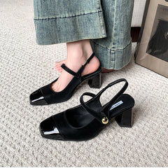 Woman wearing black square toe party sandals with jeans