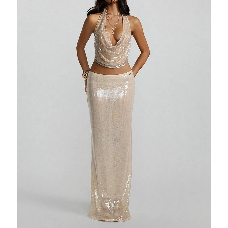 Editorial shot of gold sequin halter top styled with layered necklaces