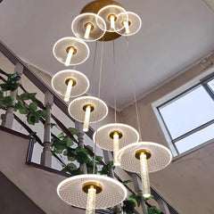Gold disc cascade chandelier in a luxury staircase foyer