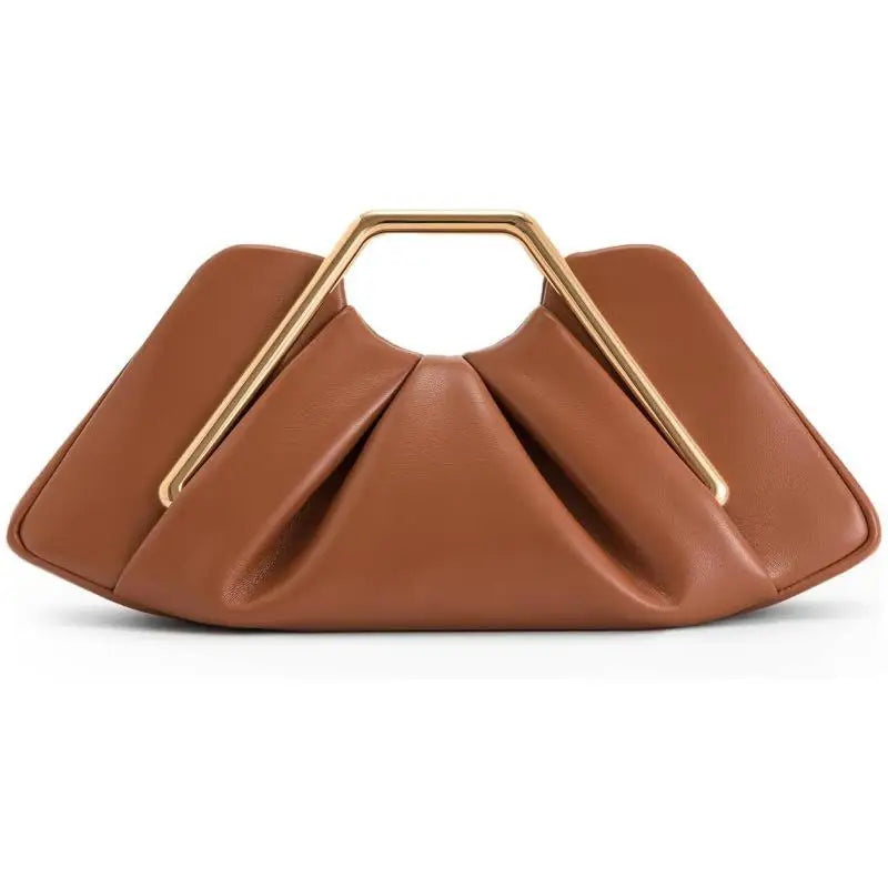 Gold handle sculptural clutch bag styled for day or evening outings