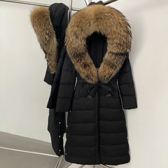 Belted waist detail on a long quilted puffer, highlighting the adjustable tie and clean, streamlined shaping through the body.