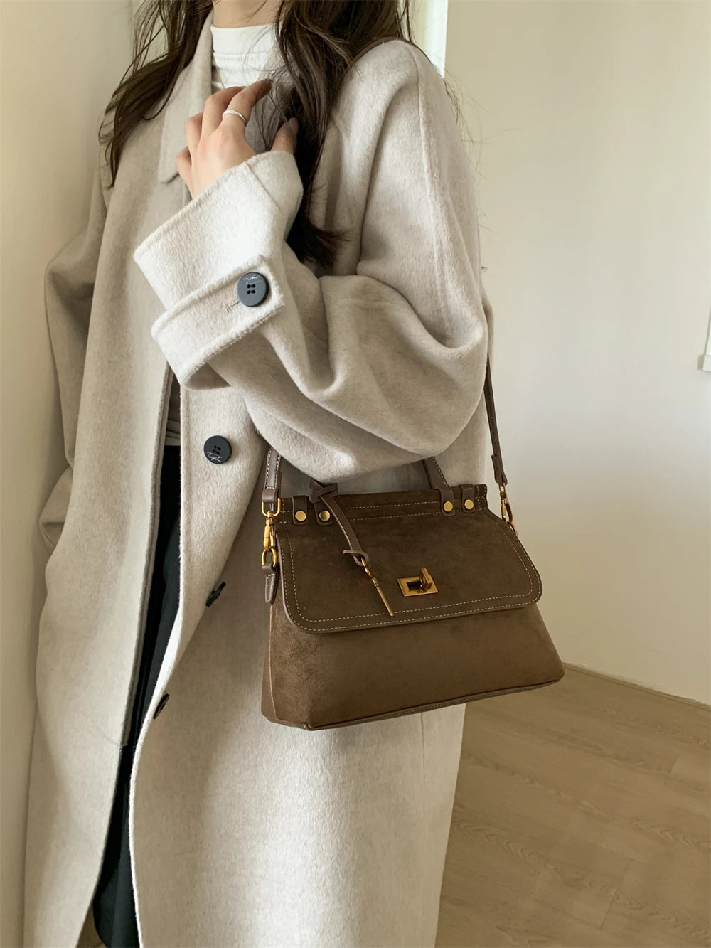 Brown retro-style saddle handbag in faux suede with top handle and hasp closure