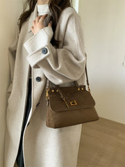 Brown retro-style saddle handbag in faux suede with top handle and hasp closure