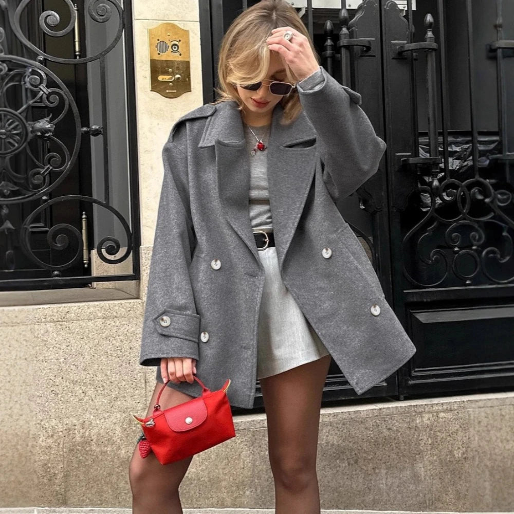 Gray double breasted blazer styled for streetwear over mini dress