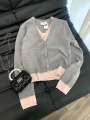 Gray cardigan with pink trim folded on chair for junior autumn